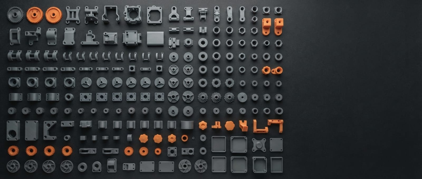 Rows of 3D printed parts laid out on a workbench: gears, brackets, hinges, housings, clips and impellers